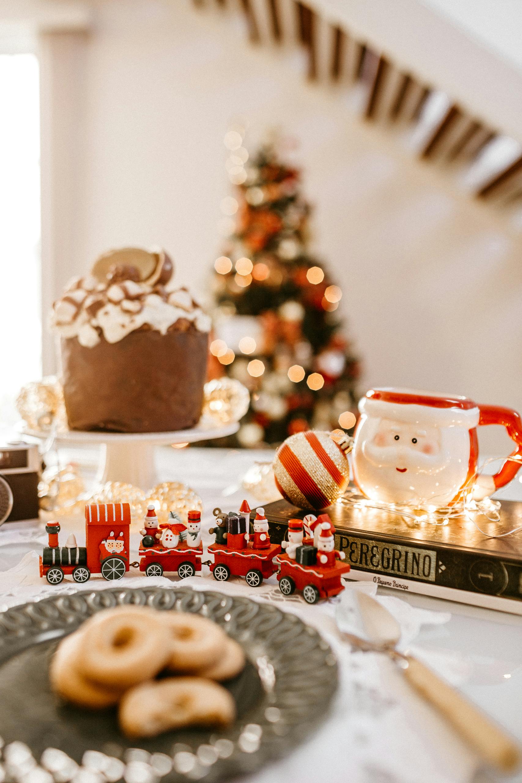 Selective Focus Photography of Christmas Train and Santa Claus Mug on Table